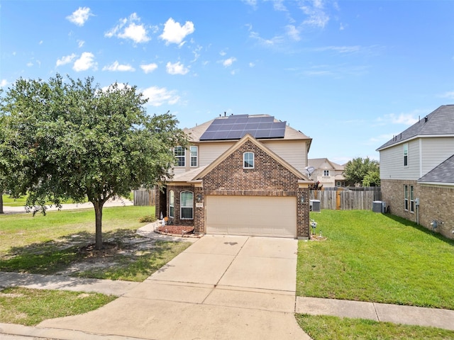 19034 Ashford Square St, Tomball, TX 77375 - traditional-style house featuring brick siding, roof mounted solar panels, concrete driveway, central AC, and a garage
