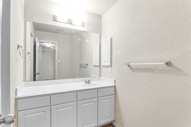 19034 Ashford Square St, Tomball, TX 77375 - bathroom featuring a textured wall and vanity