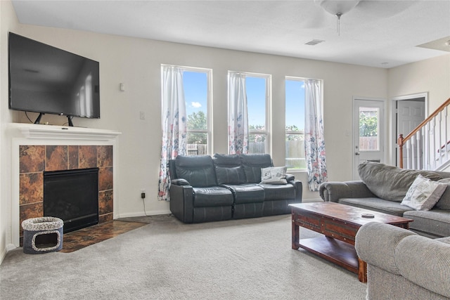 19034 Ashford Square St, Tomball, TX 77375 - carpeted living area with a tile fireplace and stairs