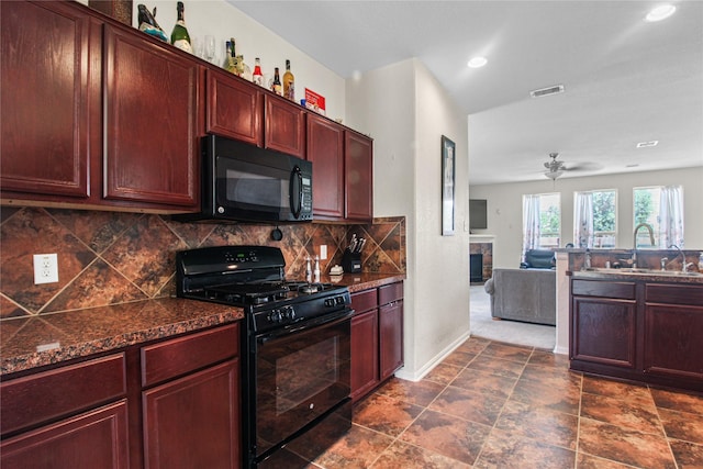 19034 Ashford Square St, Tomball, TX 77375 - kitchen featuring black appliances, reddish brown cabinets, backsplash, a tiled fireplace, and open floor plan