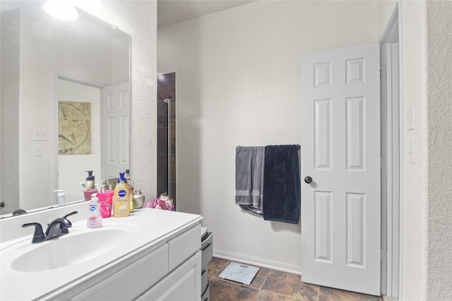 19034 Ashford Square St, Tomball, TX 77375 - bathroom featuring vanity, a textured wall, and stone finish flooring