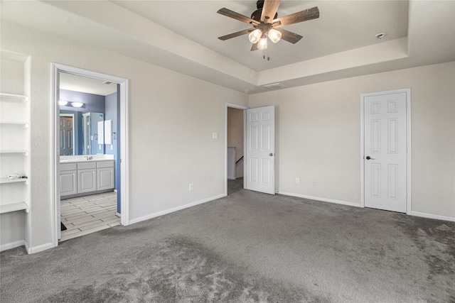 19034 Ashford Square St, Tomball, TX 77375 - unfurnished bedroom with carpet floors, ensuite bathroom, and a raised ceiling