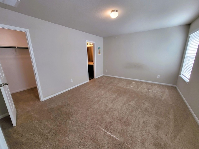 24703 Allori Ct, Katy, TX 77493 - unfurnished bedroom with a spacious closet, carpet, baseboards, and a closet