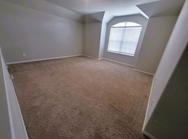 24703 Allori Ct, Katy, TX 77493 - additional living space with lofted ceiling, light carpet, and baseboards