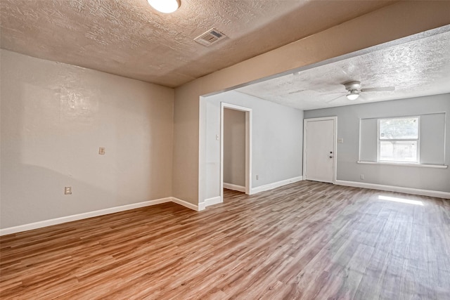 10613 Buffum St, Houston, TX 77051 - empty room with a textured ceiling, light wood-type flooring, baseboards, and a ceiling fan