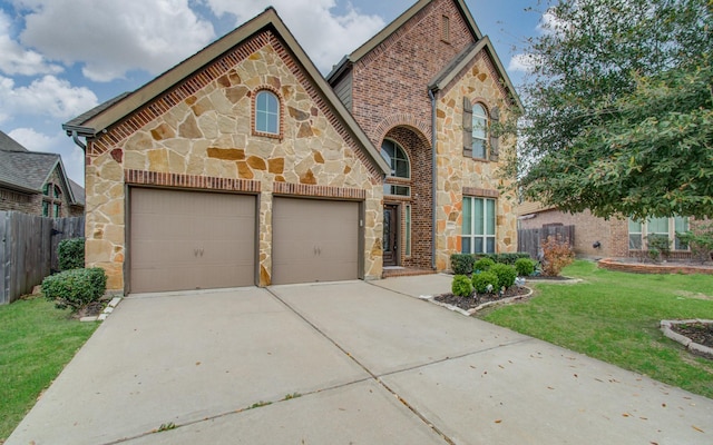 1202 Watercrest Park Ln, Rosenberg, TX 77471 - view of front facade with stone siding, an attached garage, and concrete driveway