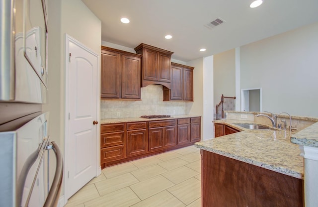 1202 Watercrest Park Ln, Rosenberg, TX 77471 - kitchen with a sink, decorative backsplash, light stone countertops, and recessed lighting