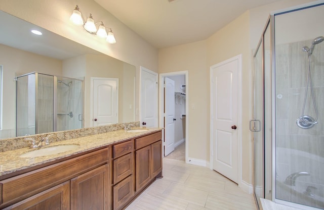 1202 Watercrest Park Ln, Rosenberg, TX 77471 - full bath with a stall shower, double vanity, a walk in closet, and baseboards