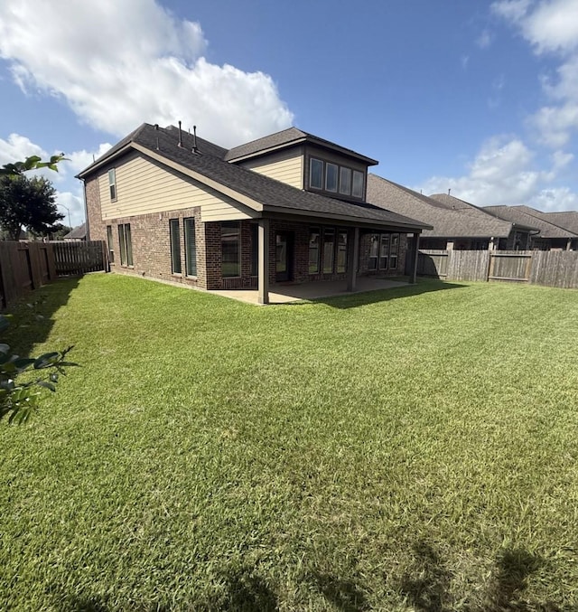 1202 Watercrest Park Ln, Rosenberg, TX 77471 - rear view of house with brick siding, a patio area, and roof with shingles