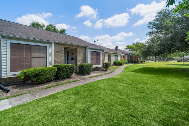8952 Wilcrest Dr Unit 8952, Houston, TX 77099 - view of front of home featuring a front lawn and a shingled roof
