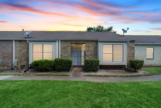 8952 Wilcrest Dr Unit 8952, Houston, TX 77099 - view of front facade with a shingled roof, a yard, and brick siding
