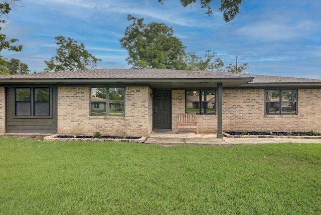 229 Burkett St, Richwood, TX 77531 - ranch-style home with a front yard, brick siding, a porch, and roof with shingles