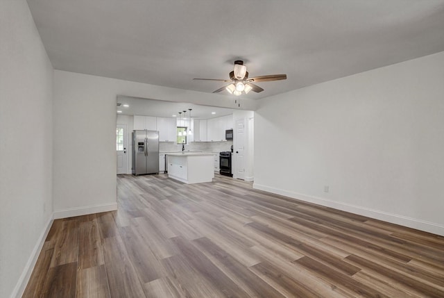 229 Burkett St, Richwood, TX 77531 - unfurnished living room with a ceiling fan, light wood-style flooring, and recessed lighting