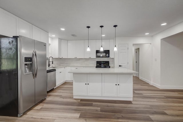229 Burkett St, Richwood, TX 77531 - kitchen with appliances with stainless steel finishes, light countertops, light wood-style flooring, white cabinets, and tasteful backsplash