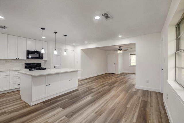 229 Burkett St, Richwood, TX 77531 - kitchen with black appliances, recessed lighting, white cabinetry, light wood-style floors, and tasteful backsplash