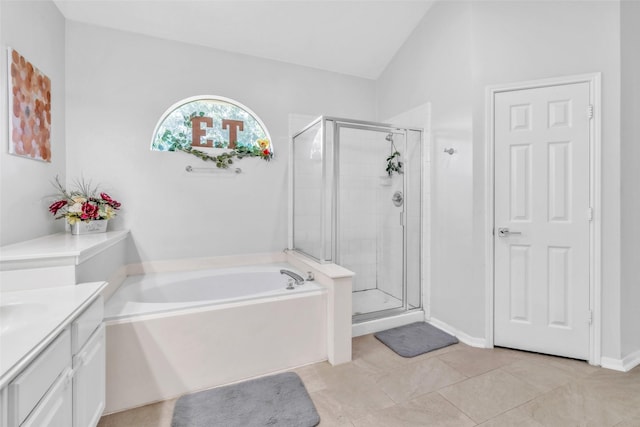 19311 Oak Station Dr, Humble, TX 77346 - bathroom with a garden tub, a shower stall, vanity, vaulted ceiling, and tile patterned flooring