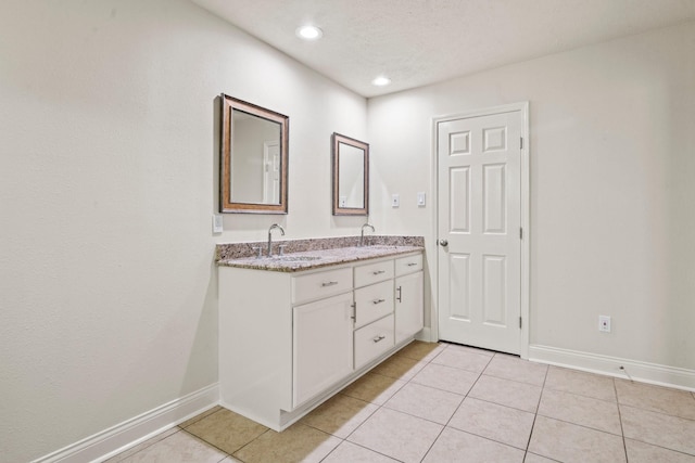 12006 Acorn Oak St, The Woodlands, TX 77380 - bathroom featuring double vanity, baseboards, tile patterned floors, and recessed lighting