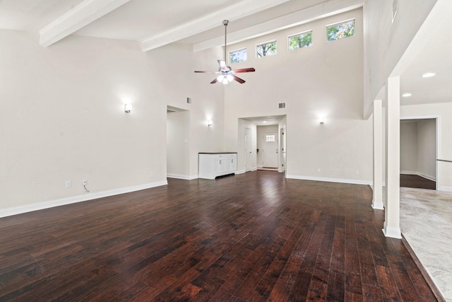 12006 Acorn Oak St, The Woodlands, TX 77380 - unfurnished living room featuring a ceiling fan, beam ceiling, hardwood / wood-style flooring, baseboards, and a towering ceiling