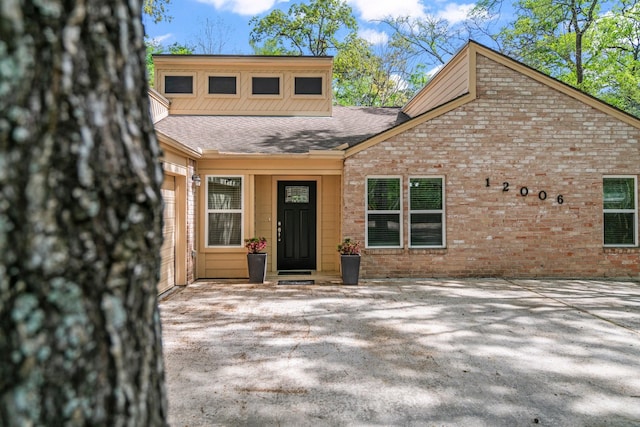 12006 Acorn Oak St, The Woodlands, TX 77380 - view of front of house featuring a shingled roof and brick siding