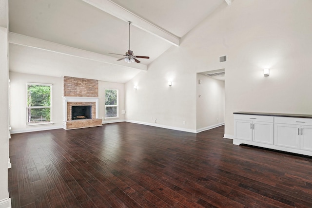12006 Acorn Oak St, The Woodlands, TX 77380 - unfurnished living room with ceiling fan, beamed ceiling, dark wood-style floors, baseboards, and a fireplace