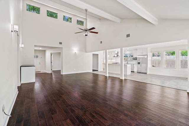 12006 Acorn Oak St, The Woodlands, TX 77380 - unfurnished living room featuring a ceiling fan, beamed ceiling, wood finished floors, high vaulted ceiling, and baseboards