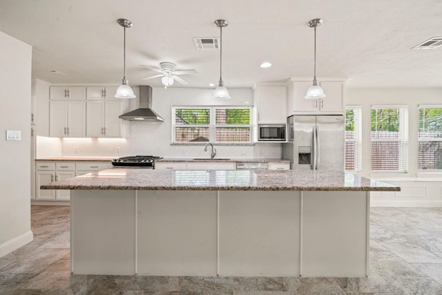 12006 Acorn Oak St, The Woodlands, TX 77380 - kitchen with wall chimney exhaust hood, stainless steel appliances, a sink, and decorative backsplash
