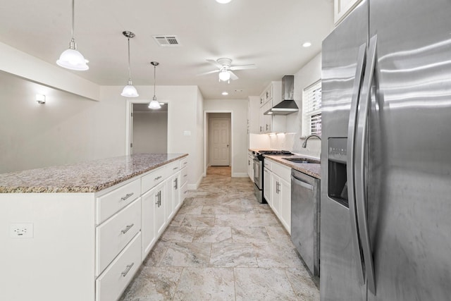 12006 Acorn Oak St, The Woodlands, TX 77380 - kitchen featuring stainless steel appliances, a sink, wall chimney exhaust hood, a center island, and white cabinets