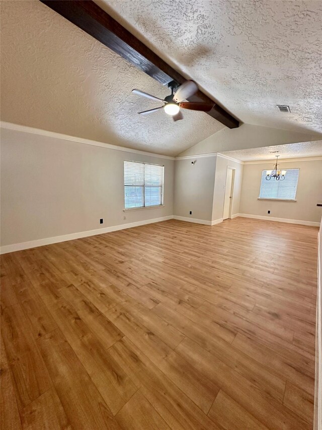 11807 Monticeto Ln, Meadows Place, TX 77477 - unfurnished living room featuring a textured ceiling, light wood-style flooring, a chandelier, a ceiling fan, and baseboards