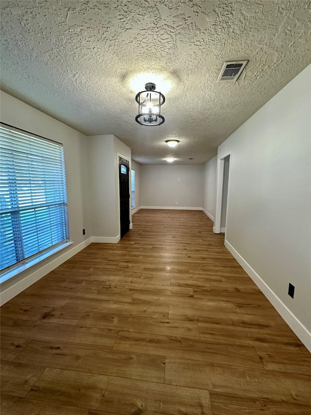 11807 Monticeto Ln, Meadows Place, TX 77477 - empty room featuring wood finished floors, baseboards, and a textured ceiling