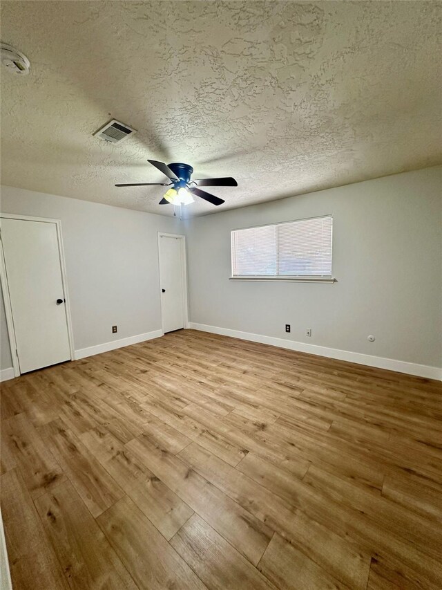 11807 Monticeto Ln, Meadows Place, TX 77477 - unfurnished room with light wood-style floors, ceiling fan, a textured ceiling, baseboards, and a smoke detector