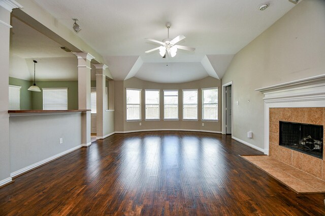2627 Old River Ln, Richmond, TX 77406 - unfurnished living room featuring a ceiling fan, baseboards, wood finished floors, a tile fireplace, and vaulted ceiling