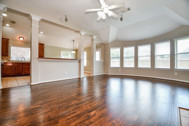 2627 Old River Ln, Richmond, TX 77406 - unfurnished living room with a ceiling fan, lofted ceiling, decorative columns, wood finished floors, and a sink