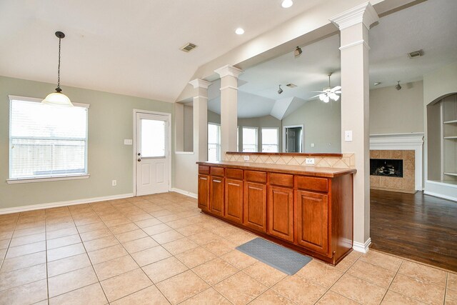 2627 Old River Ln, Richmond, TX 77406 - kitchen featuring ornate columns, a ceiling fan, lofted ceiling, open floor plan, and plenty of natural light
