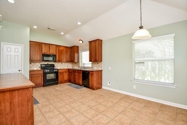 2627 Old River Ln, Richmond, TX 77406 - kitchen with black appliances, lofted ceiling, backsplash, brown cabinets, and light countertops