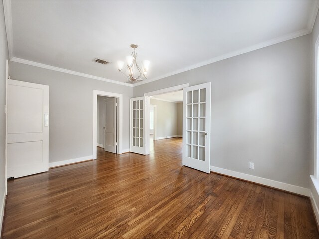 1634 Castle Ct, Houston, TX 77006 - empty room featuring a chandelier, baseboards, wood finished floors, and ornamental molding