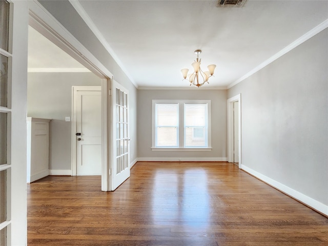 1634 Castle Ct, Houston, TX 77006 - unfurnished dining area featuring a chandelier, wood finished floors, ornamental molding, and baseboards
