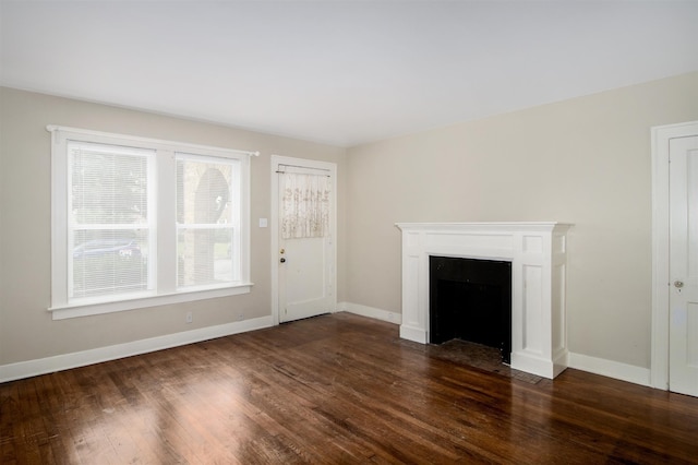1634 Castle Ct, Houston, TX 77006 - unfurnished living room with dark wood-type flooring, baseboards, and a fireplace