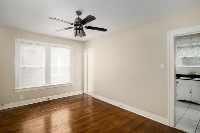 1634 Castle Ct, Houston, TX 77006 - empty room with a sink, wood finished floors, ceiling fan, and baseboards