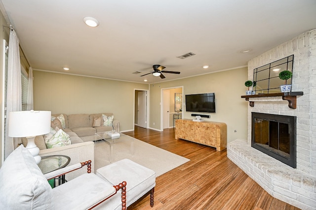 2730 Manila Ln, Houston, TX 77043 - living room with a ceiling fan, recessed lighting, a brick fireplace, crown molding, and wood finished floors