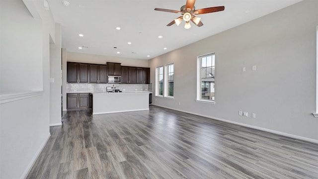 9423 Towne Lake Pkwy, Cypress, TX 77433 - unfurnished living room featuring a ceiling fan, wood finished floors, and recessed lighting