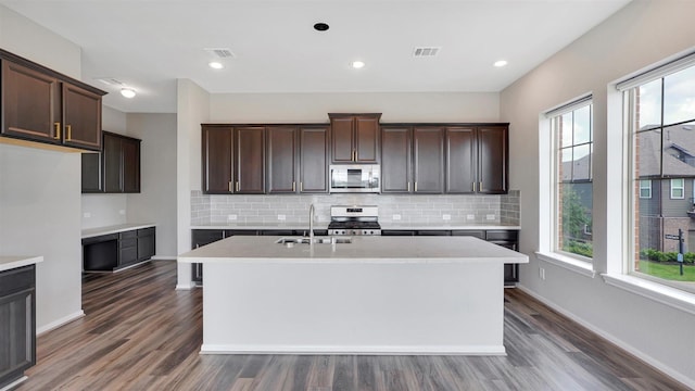 9423 Towne Lake Pkwy, Cypress, TX 77433 - kitchen featuring stainless steel appliances, wood finished floors, backsplash, and recessed lighting
