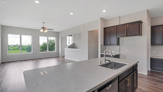 9423 Towne Lake Pkwy, Cypress, TX 77433 - kitchen featuring stainless steel dishwasher, a ceiling fan, dark wood finished floors, open floor plan, and light stone countertops