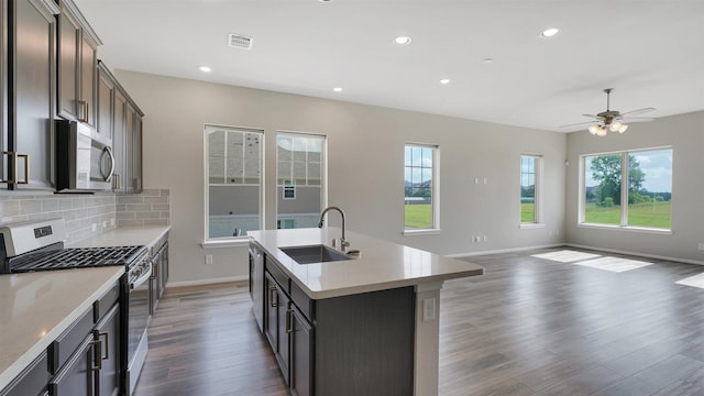 9423 Towne Lake Pkwy, Cypress, TX 77433 - kitchen featuring appliances with stainless steel finishes, dark wood-style floors, healthy amount of natural light, backsplash, and recessed lighting