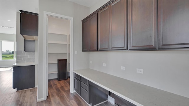 9423 Towne Lake Pkwy, Cypress, TX 77433 - kitchen featuring dark wood-style floors, dark brown cabinetry, light countertops, and tasteful backsplash