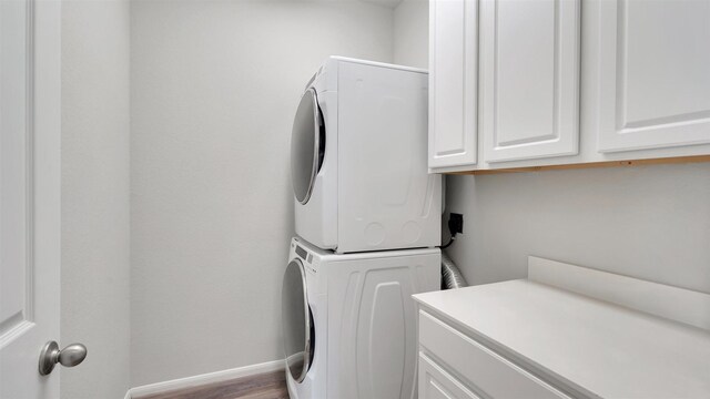 9423 Towne Lake Pkwy, Cypress, TX 77433 - washroom featuring cabinet space and stacked washer / drying machine