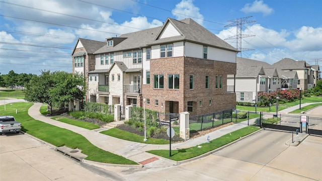 9423 Towne Lake Pkwy, Cypress, TX 77433 - view of home's exterior featuring a gate, brick siding, a residential view, and stone siding