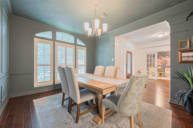 1942 Crisfield Dr, Sugar Land, TX 77479 - dining room featuring dark wood-style floors, french doors, a chandelier, crown molding, and a textured ceiling
