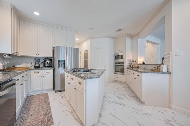 1942 Crisfield Dr, Sugar Land, TX 77479 - kitchen featuring stainless steel appliances, a kitchen island, light marble finish floors, tasteful backsplash, and recessed lighting