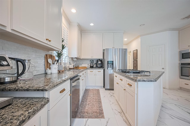 1942 Crisfield Dr, Sugar Land, TX 77479 - kitchen with stainless steel appliances, a kitchen island, light marble finish flooring, backsplash, and recessed lighting