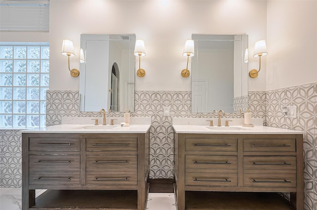 1942 Crisfield Dr, Sugar Land, TX 77479 - bathroom featuring two vanities, wainscoting, and tile walls